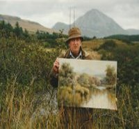 Hamilton Sloan traditional irish artist wearing donegal tweed coat and hat holding a painting of the clady river and mount Errigal standing in front of the clady river and mount Errigal