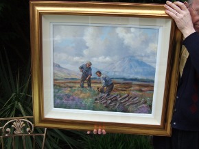 H Sloan holding framed painting
