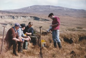 photo of four turf cutters having tea break at gweedore county donegal