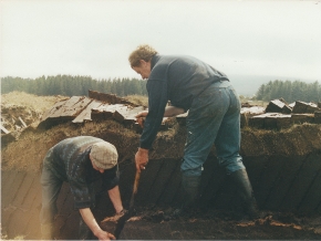 two native Donegal men cutting sods of turf