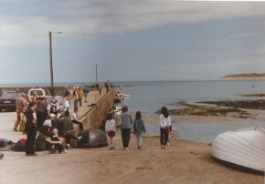 people waiting at the pier for the boat to tory island 