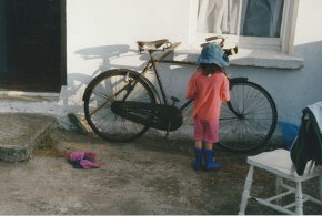 Hamilton Sloans niece catherine looking at a bicycle outside the cottage county Donegal